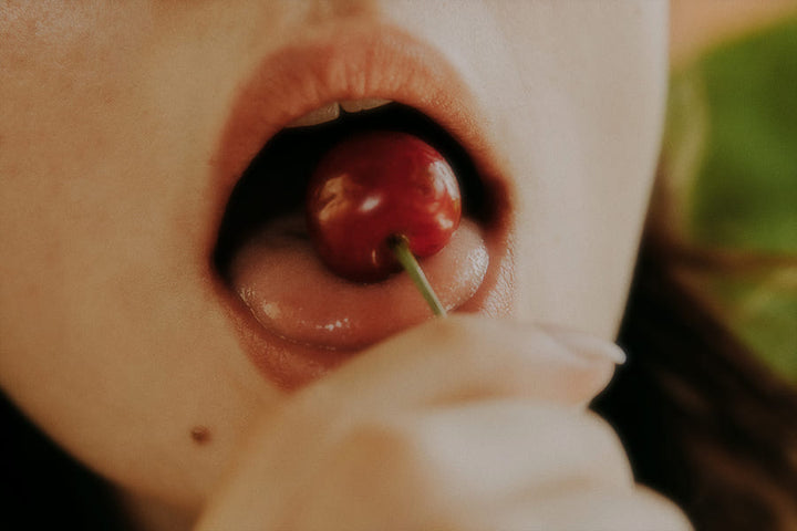 cherry going into womens mouth on her tongue 