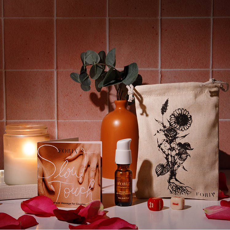 Foria Desire Dice Kit lifestyle products and accessories on a table with a tiled wall background