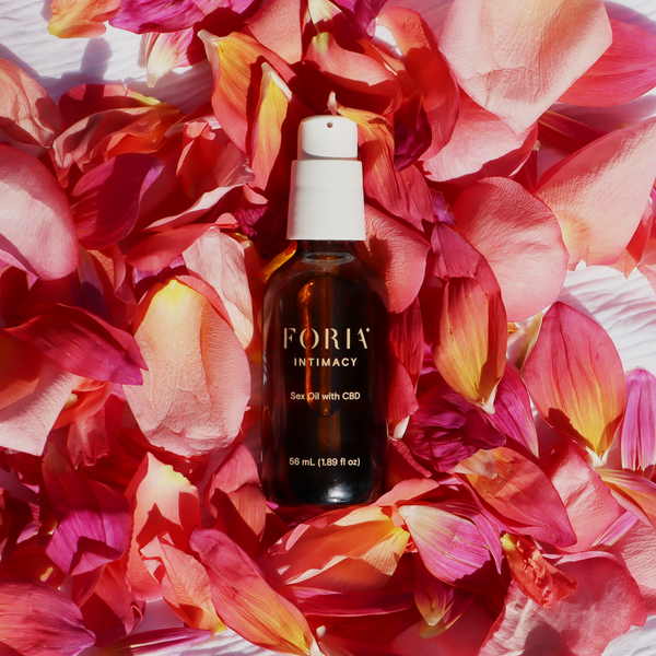 Foria Sex Oil with CBD  on flowers, plant-based intimacy oil for comfort and arousal