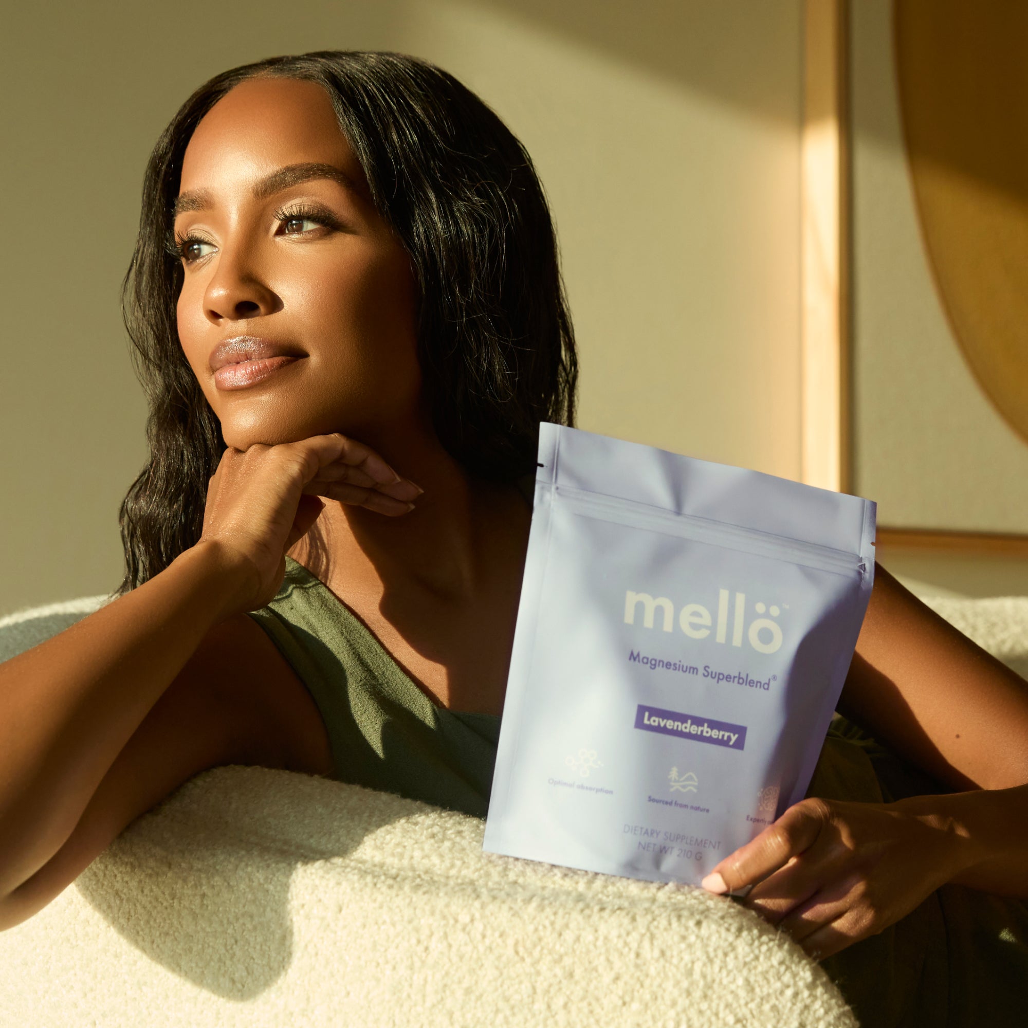 Woman holding a mello product package in a sunlit room