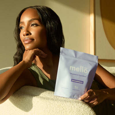 Woman holding a mello product package in a sunlit room