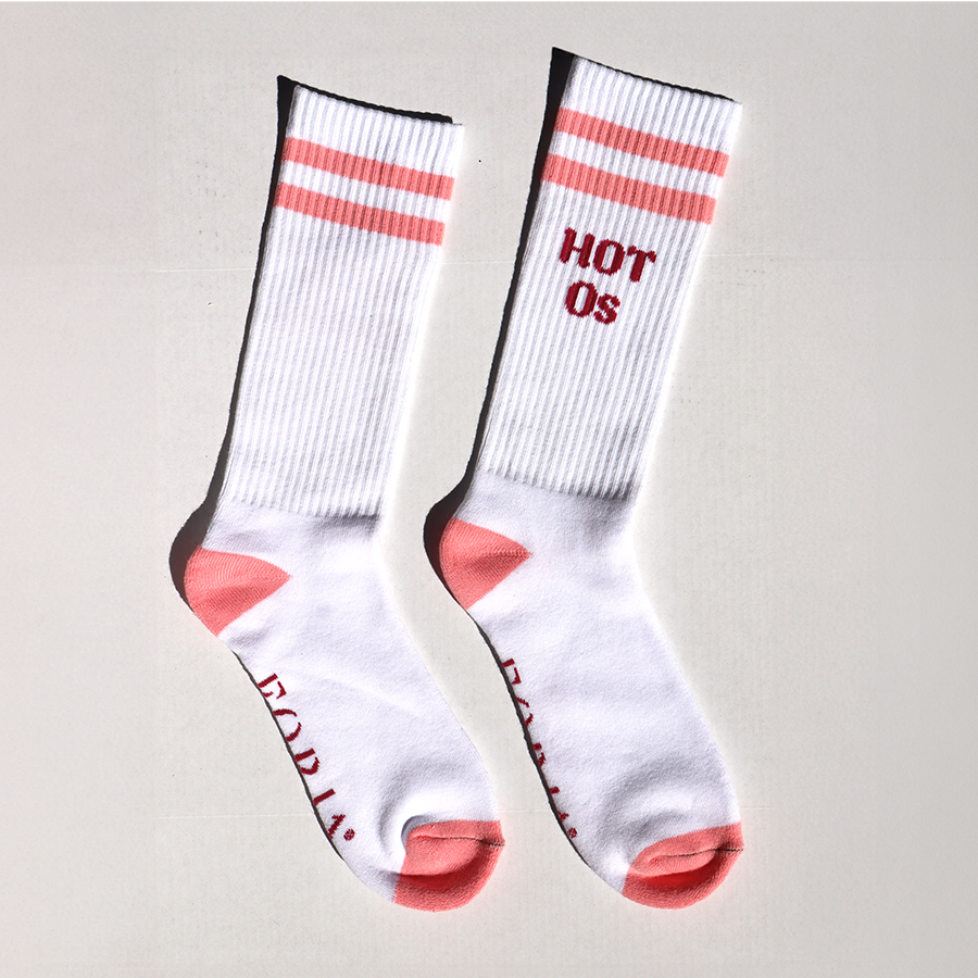 A pair of white socks with pink stripes and text reading 'HOT Os' on the foot area.