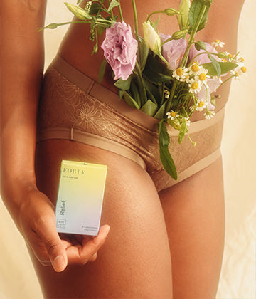 Person in underware with flowers and Relief melts. Made to ease pelvic pain. 